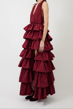 Women's burgundy deep-V evening gown with a high slit.