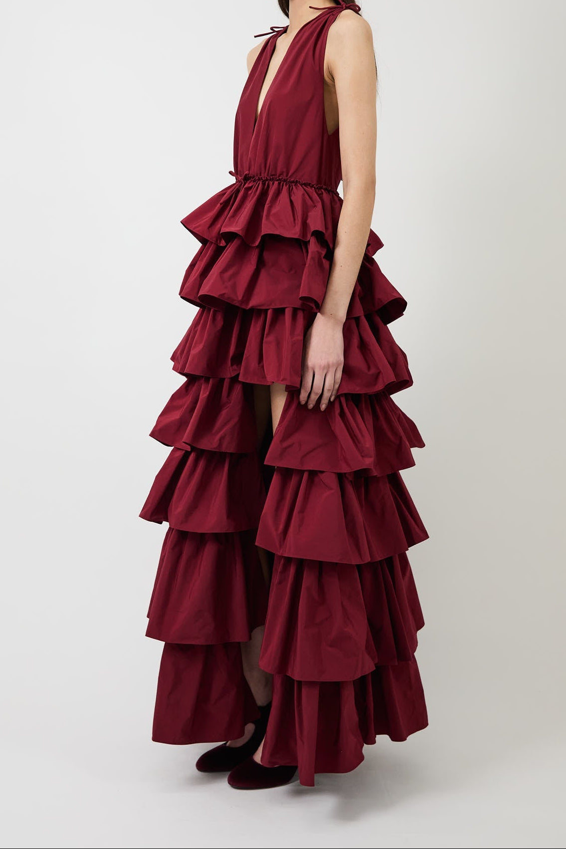 Women's burgundy deep-V evening gown with a high slit.