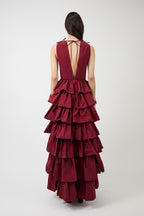 Women's burgundy deep-V evening gown with a high slit.