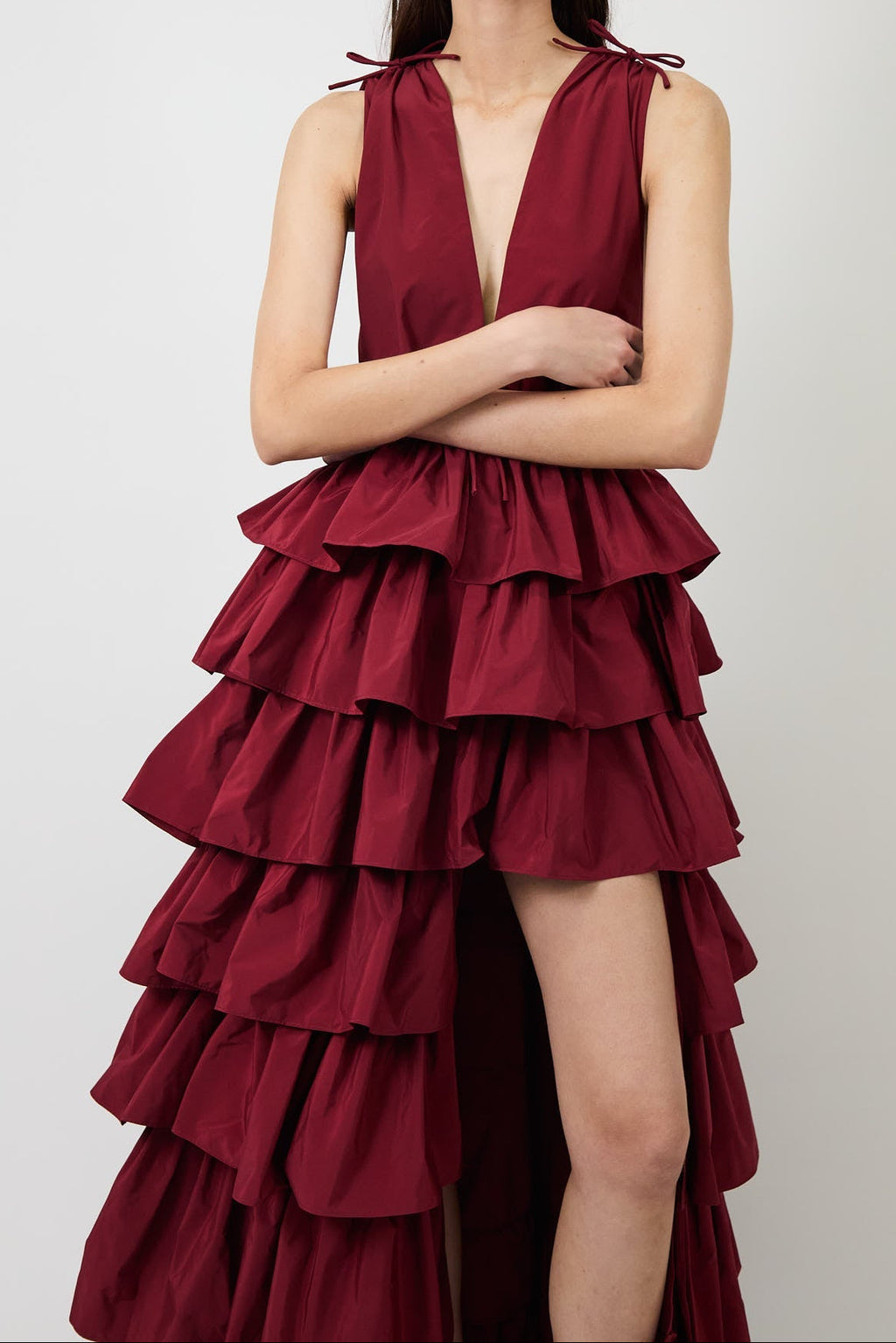 Women's burgundy deep-V evening gown with a high slit.
