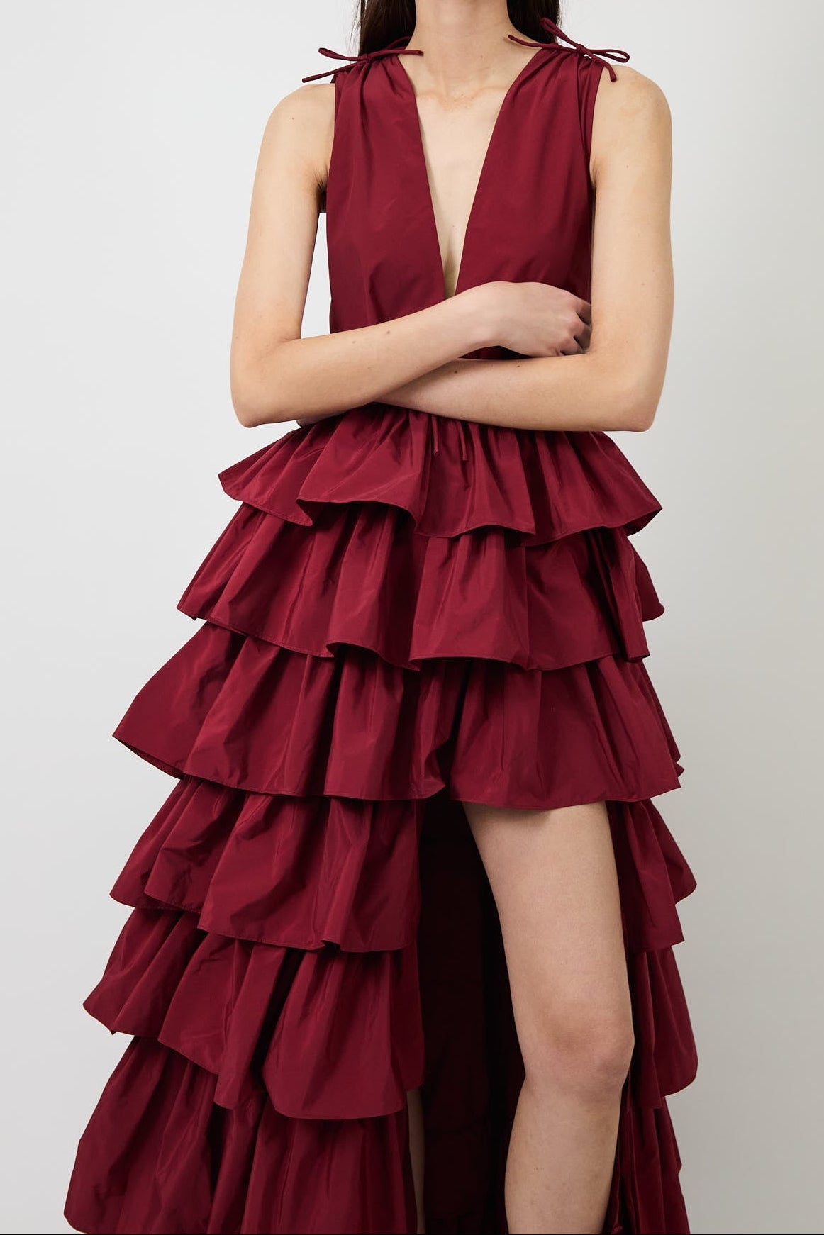 Women's burgundy deep-V evening gown with a high slit.